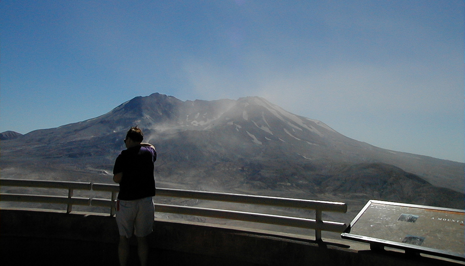 Paul standing at the Visitor's Center in front of Mount Saint Helens