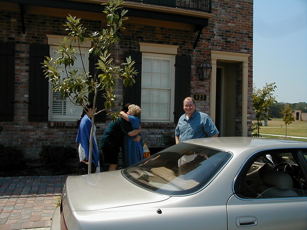 Marc, Steve and Mom hugging goodbye, and Jackie saying our goodbyes outside Mom's townhouse in River Ranch