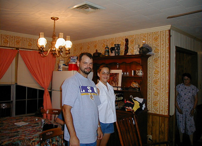 Eric, Erica, and Aunt Dory standing in Aunt Lou's house