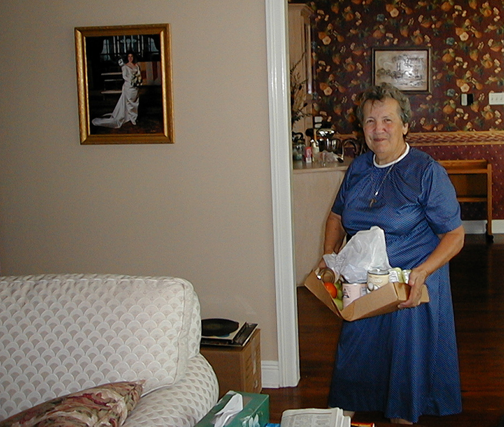 Sister Jeanette with gifts for Mom in Mom's living room