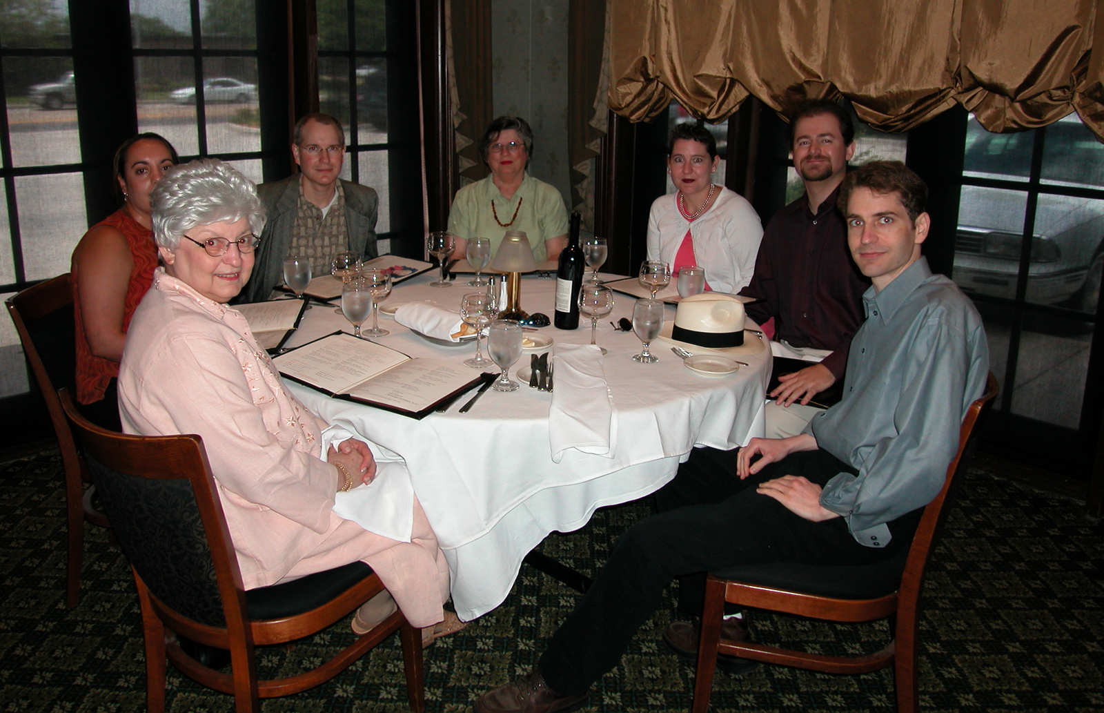 Mom, Marc's then-girlfriend Dara, Marc, Aunt Dory, Jackie and Steve, and Dan sitting in RUTH'S CHRIS Steak House® for Mother's Day meal