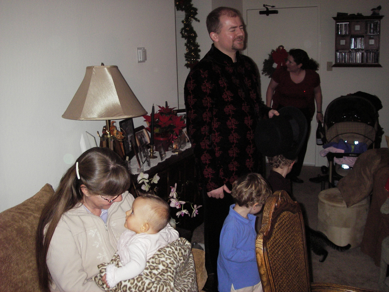Adele holding Sophia, Steve, James and John, and Jackie at a friend's house for Christmas Eve Dinner