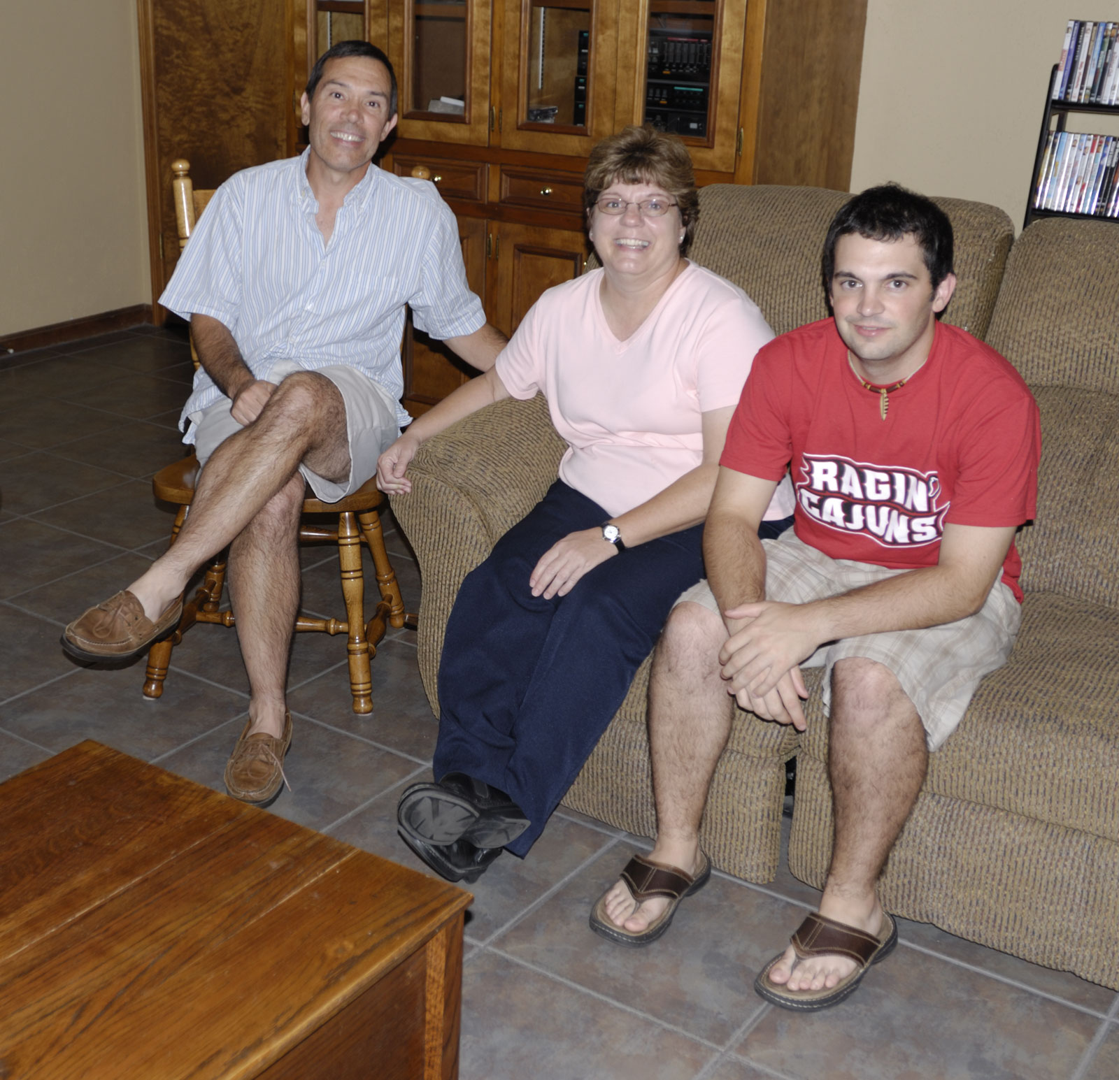 Rusty, Julie, and their son Eric in their home