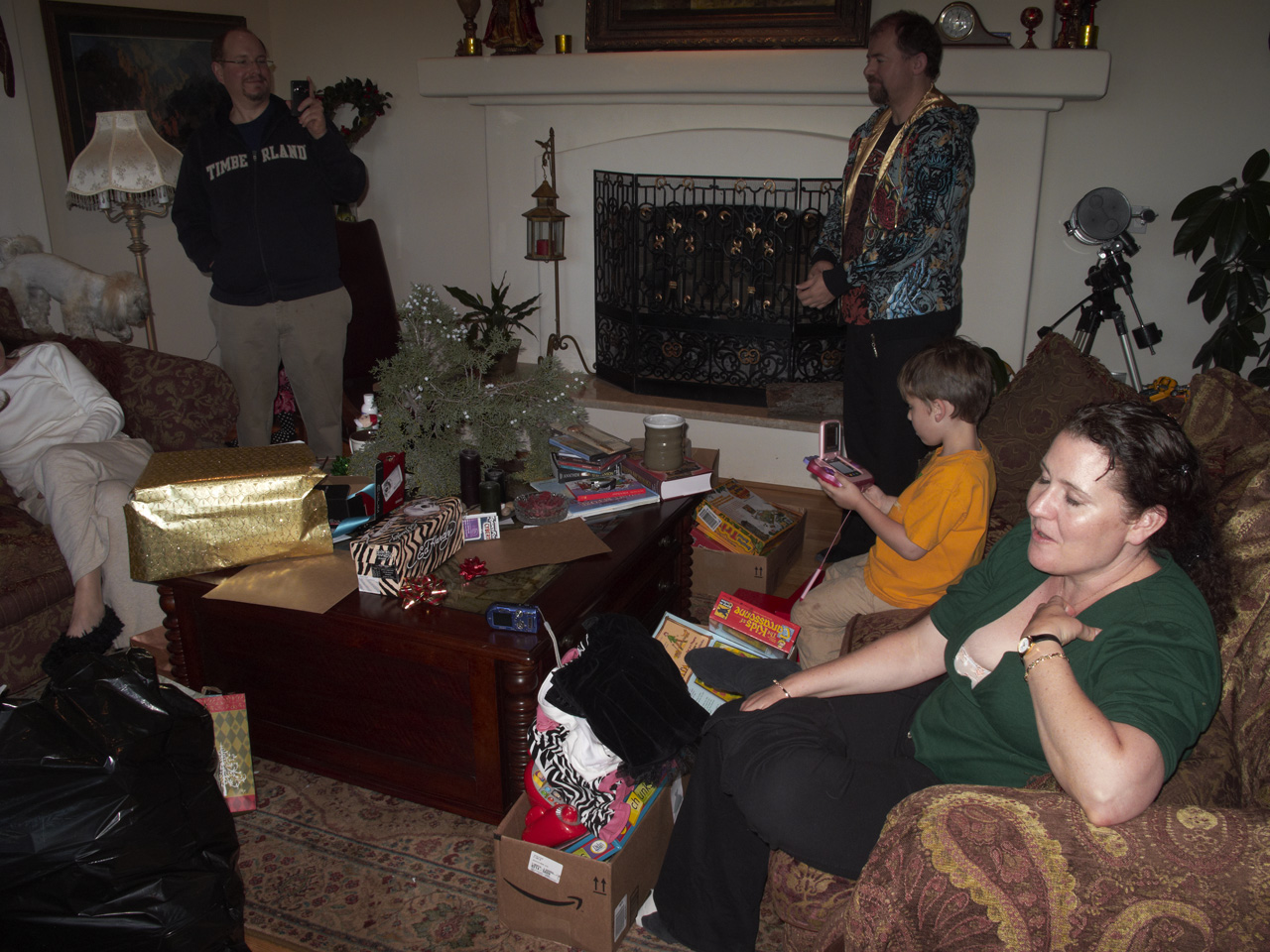 Keri and Marc, Steve, James and Jackie opening gifts on Christmas afternoon in Marc's living room