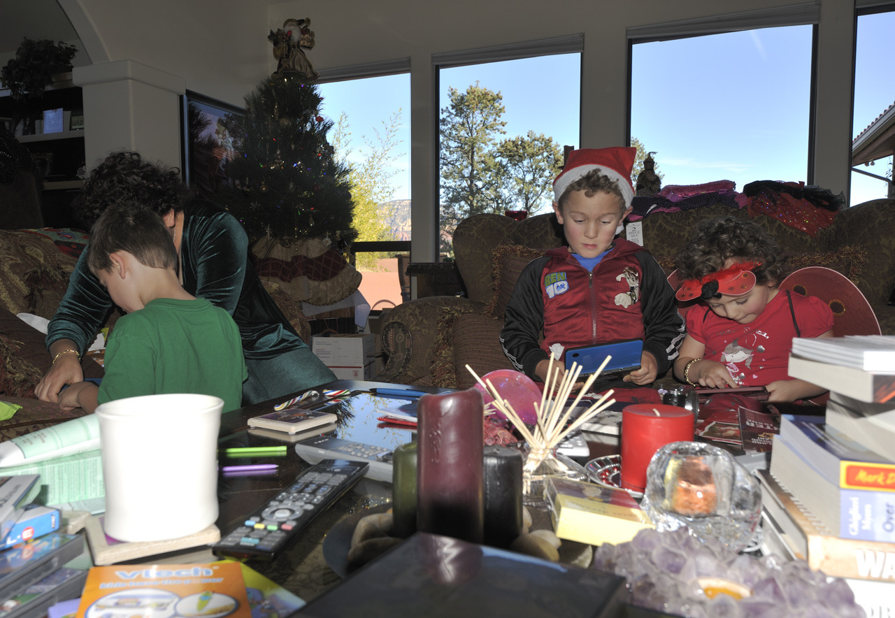 James, Jackie, John, and Sophia opening gifts on Christmas morning in Marc's living room