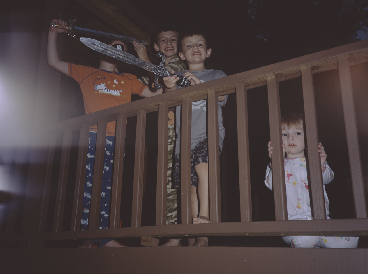 Gabriel, Jonathan, Benjamin, and Katherine playing pirates in their treehouse in their back yard