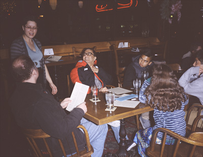 Steve giving his drink order to our server, while Naresh and Kieron watch, Sophia colors, and Mikhil waits, at our table in BLUE MOON CAFE