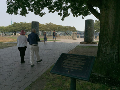 Jackie and Marc walking past the plaque commemorating the Japanese American Historical Plaza