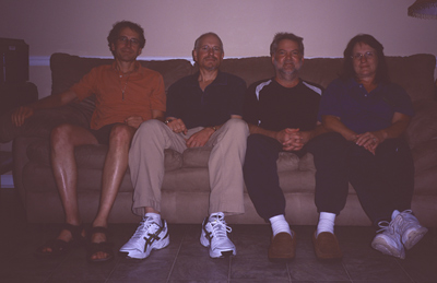 Dan, Marc, Louis and Monica sitting on Louis and Monica's sofa