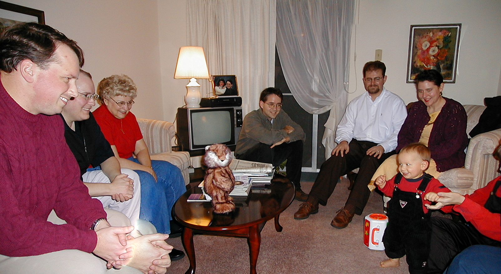 Paul, Marc, Mom, Aunt Dory, Robert, Jackie and Steve admiring baby Miles in Aunt Dory's apartment on Christmas evening