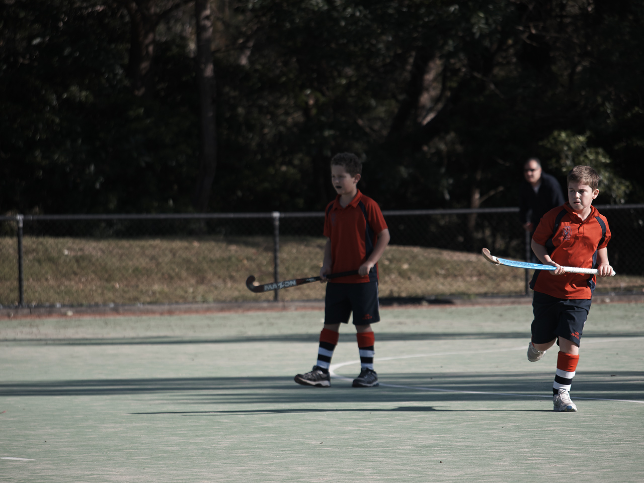 John and James playing in their last field hockey game of the season